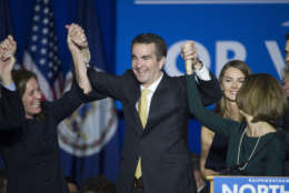 Virginia Gov.-elect Ralph Northam celebrates his election victory with his wife Pam and daughter Aubrey, right, and Dorothy McAuliffe, wife of Virginia Gov. Terry McAuliffe at the Northam For Governor election night party at George Mason University in Fairfax, Va., Tuesday, Nov. 7, 2017. (AP Photo/Cliff Owen)