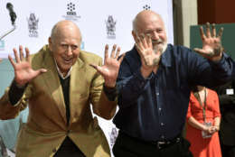 Carl Reiner, left, and his son Rob Reiner hold up their hands after putting them in cement during a hand and footprint ceremony for them at the TCL Chinese Theatre on Friday, April 7, 2017, in Los Angeles. (Photo by Chris Pizzello/Invision/AP)