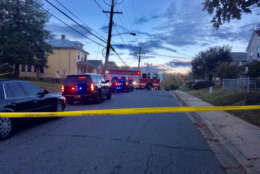 Photo shows police tape closing a road where there was a fire