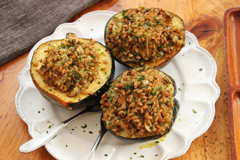 This Jan.11, 2016 photo shows an acorn squash stuffed with mushrooms, farro and winter citrus in Concord, N.H. This dish is from a recipe by Alison Ladman. (AP Photo/Matthew Mead)