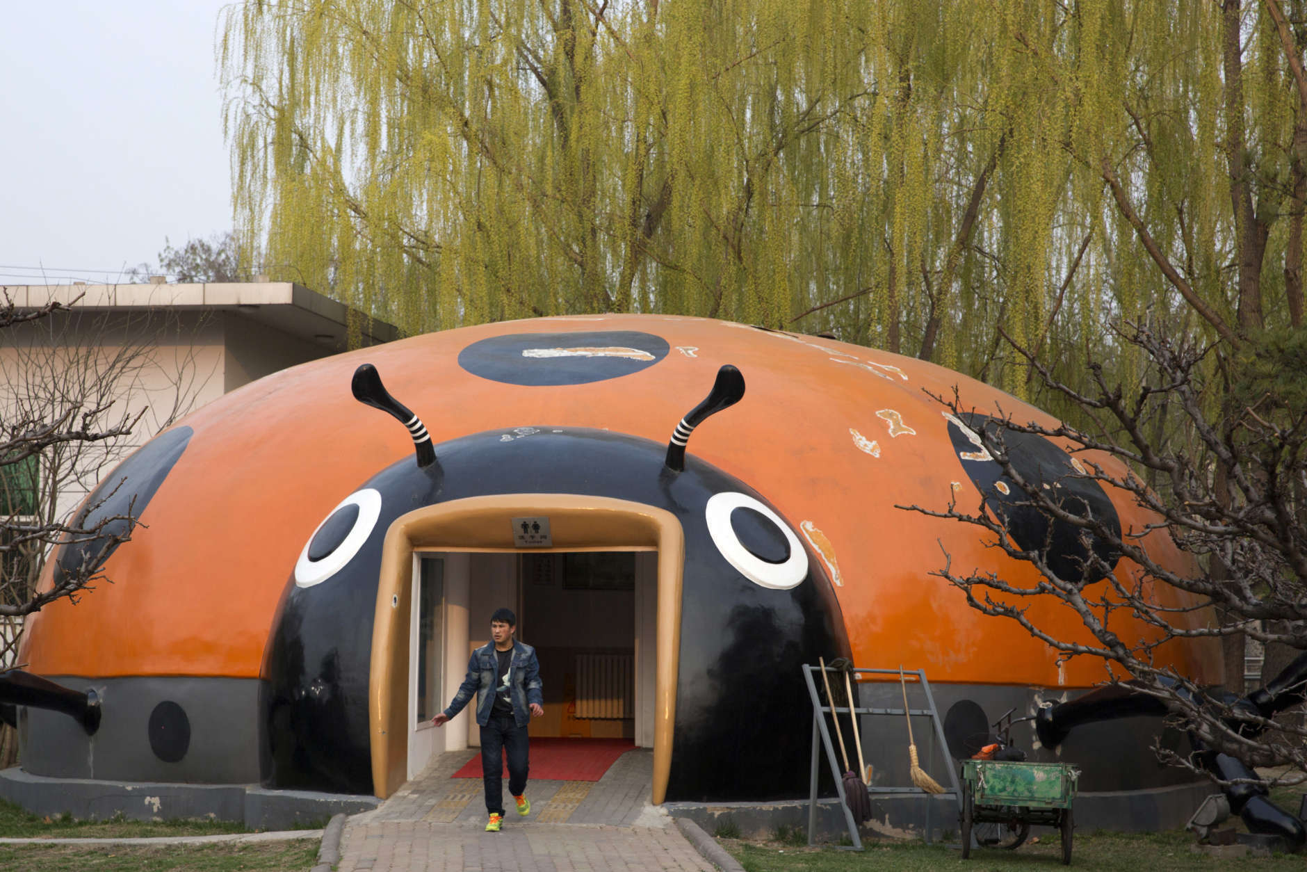 In this photo taken Wednesday, March 29, 2017, a man walks out from a ladybird shaped public toilet in Beijing, China. Launched two years ago, a "toilet revolution" campaign calls for at least 34,000 new public bathrooms to be constructed in Beijing and 23,000 renovated by the end of this year. Authorities are also encouraging the installation of Western-style sit-down commodes rather than the more common squat toilets. Around 25 billion yuan ($3.6 billion) has already been spent on the program, according to the National Tourism Administration. (AP Photo/Ng Han Guan)