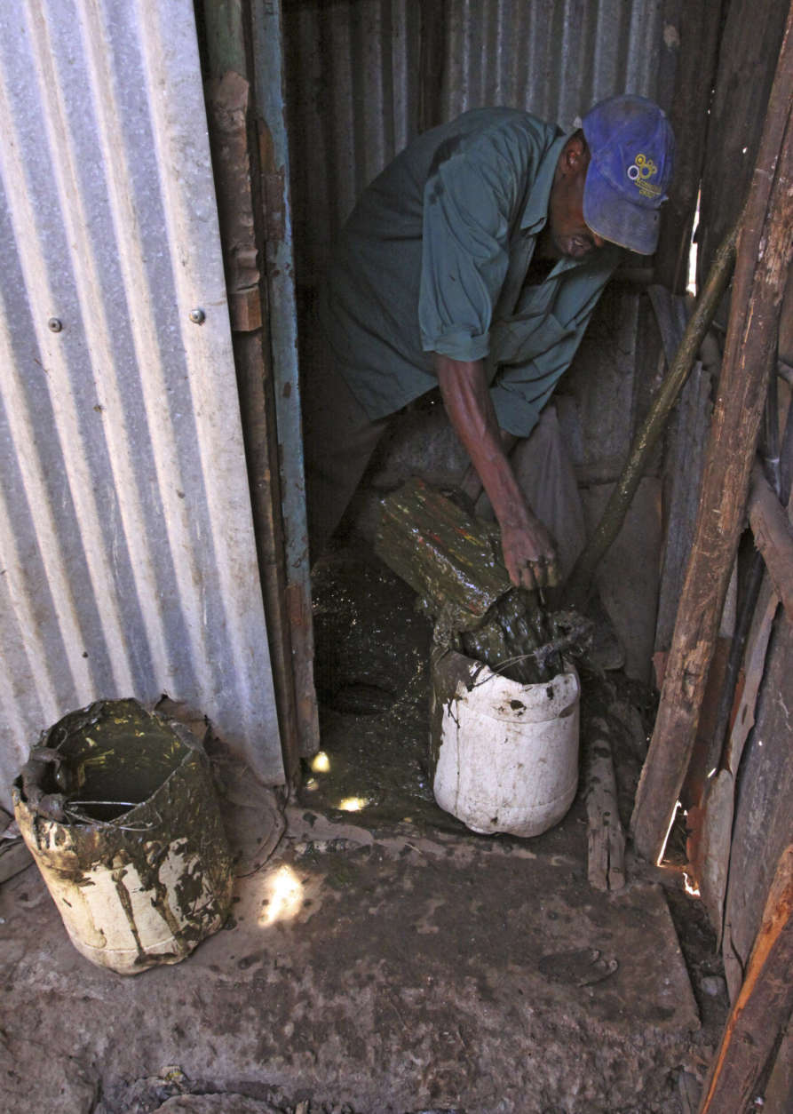 In the photo taken Sunday, July 17, 2011, in the Korogocho slums of Nairobi, Kenya as a worker tries to unclog a pit latrine, before loading a cart and dumping the effluent from slum pit latrines into a local water course. On Tuesday July 19, 2011, at the AfricaSan Conference in Kigali, Rwanda, the Bill &amp; Melinda Gates Foundation announced dlrs 42 million U.S.  in grants to encourage innovation in the capture, storage and re-purposing of waste as a potential energy resource.  About 1.5 million children are believed to die each year from disease contracted from bad sanitation and the Gates Foundation believes most of these deaths could be prevented with clean drinking water and improved hygiene.  (AP Photo/Khalil Senosi)