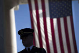 A member of the honor guard waits for the arrival of visitors to the annual Veterans Day Observance Ceremony at Arlington National Cemetery in Arlington, Va., Tuesday, Nov. 11, 2014. Americans marked Veterans Day on Tuesday with parades, speeches and military discounts, while in Europe the holiday known as Armistice Day held special meaning in the centennial year of the start of World War I.   (AP Photo/Evan Vucci)