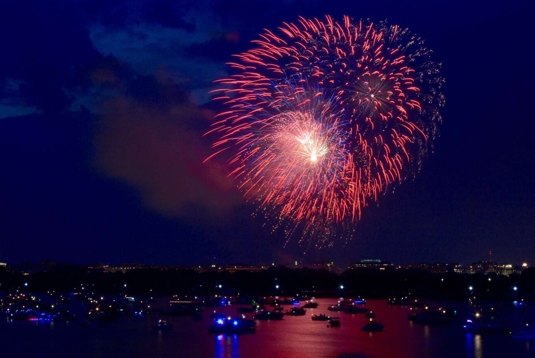 The 2017 Independence Day fireworks shimmered on the waters of the Potomac River as hundreds of spectators watched from anchored vessels. (WTOP/Dave Dildine)