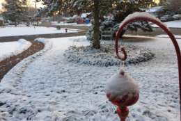 Snow coats the ground early Sunday. (WTOP/Kristi King)
