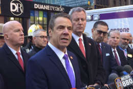 New York Gov. Andrew Cuomo speaks to members of the media after a pipe bomb strapped to a man went off in a New York City subway near Times Square on Monday, Dec. 11, 2017, in New York. Mayor Bill de Blasio stands fourth from left. (AP Photo/Mark Lennihan)