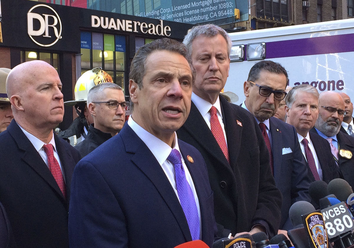New York Gov. Andrew Cuomo speaks to members of the media after a pipe bomb strapped to a man went off in a New York City subway near Times Square on Monday, Dec. 11, 2017, in New York. Mayor Bill de Blasio stands fourth from left. (AP Photo/Mark Lennihan)