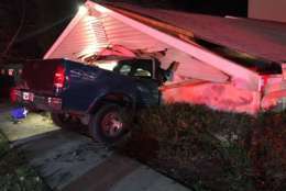Authorities say two people are being treated for serious injuries after a truck crashed into a house in Anne Arundel County. (Courtesy Annapolis Fire Department)