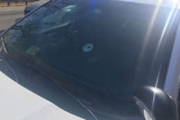 Authorities said the SUV driver fired shots at both a Virginia State Trooper and a Stafford County Sheriff's deputy. The gunman's bullets struck and penetrated the windshields of both vehicles, authorities said. This photo shows the deputy's vehicle with the bullet hole. (Courtesy Virginia State Police)