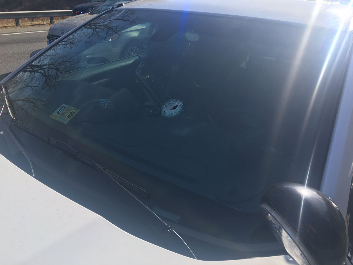 Authorities said the SUV driver fired shots at both a Virginia State Trooper and a Stafford County Sheriff's deputy. The gunman's bullets struck and penetrated the windshields of both vehicles, authorities said. This photo shows the deputy's vehicle with the bullet hole. (Courtesy Virginia State Police)