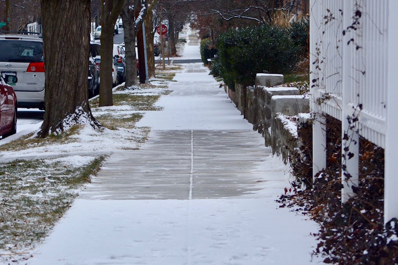Snow checkers a sidewalk in D.C. Residents are required to shovel. (WTOP/Dave Dildine)