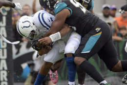 Jacksonville Jaguars defensive lineman Calais Campbell, right, sacks Indianapolis Colts quarterback Jacoby Brissett during the first half of an NFL football game, Sunday, Dec. 3, 2017, in Jacksonville, Fla. (AP Photo/Phelan M. Ebenhack)