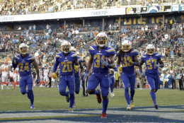 Members of the Los Angeles Chargers celebrate their win against the Cleveland Browns during the second half of an NFL football game Sunday, Dec. 3, 2017, in Carson, Calif. (AP Photo/Jae C. Hong)