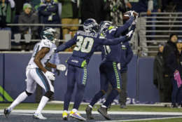 Seattle Seahawks' Byron Maxwell, right, intercepts a pass in the end zone meant for Philadelphia Eagles' Nelson Agholor, left, as Bradley McDougald (30) helps defend during the second half of an NFL football game, Sunday, Dec. 3, 2017, in Seattle. (AP Photo/Ted S. Warren)