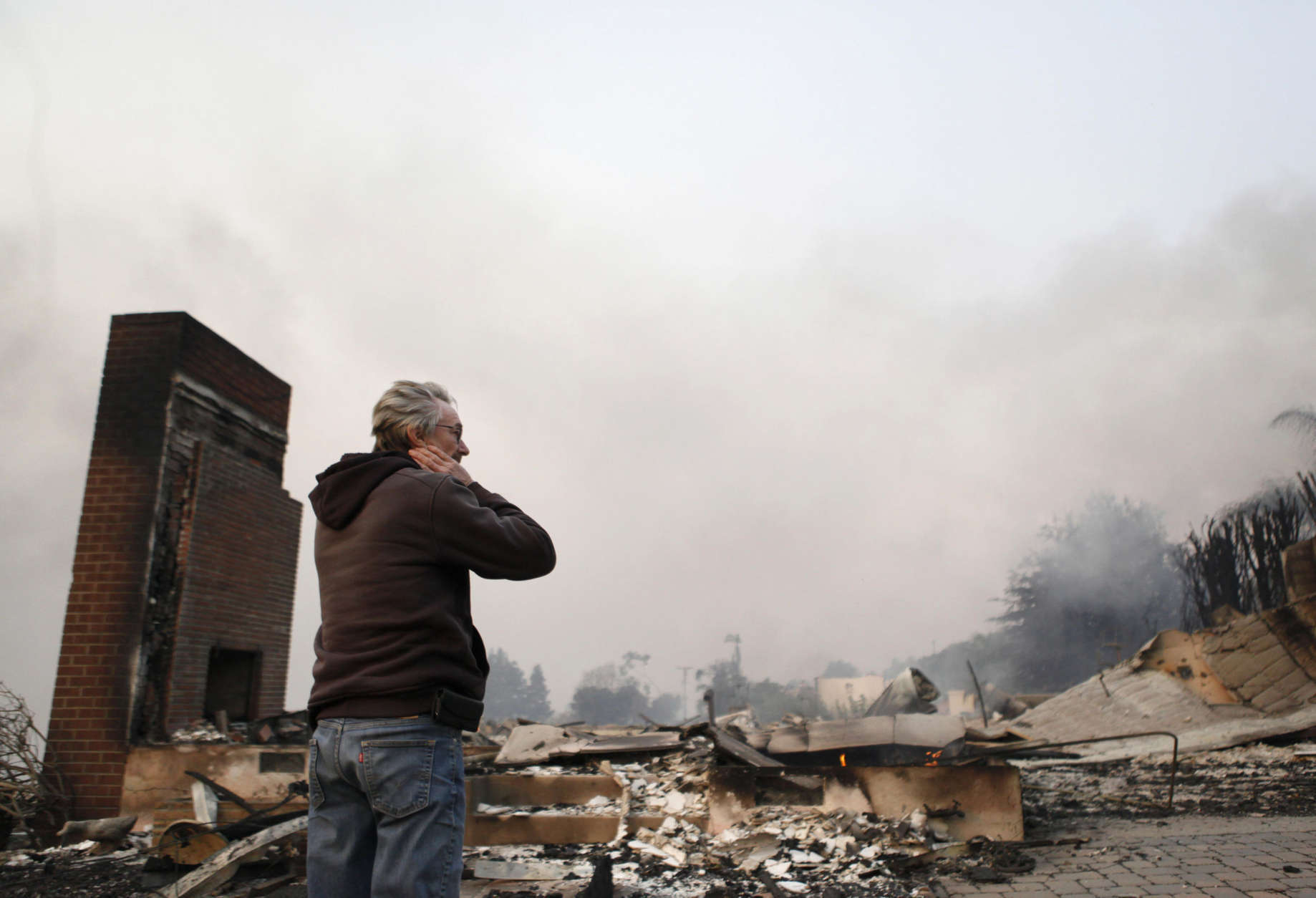 Greg Smith stands amid the ruins of his home after the Thomas fire swept through Ventura, Calif., Tuesday, Dec. 5, 2017. (Daniel Dreifuss via AP)