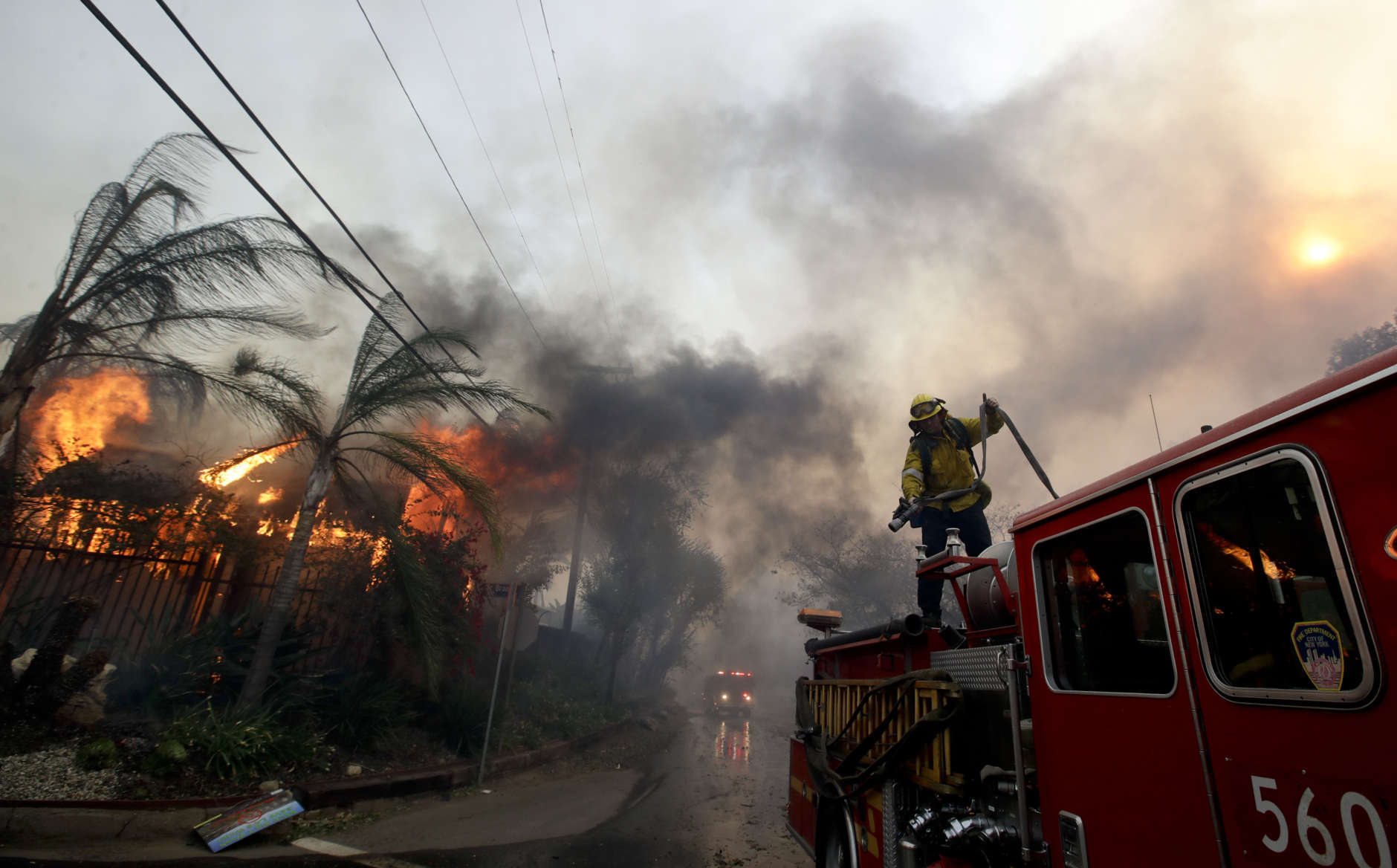 A Los Angeles County firefighter prepares to battle a hot spot on the "Creek Fire" in the Lake View Terrace area of Los Angeles, Tuesday, Dec. 5, 2017. (AP Photo/Chris Carlson)