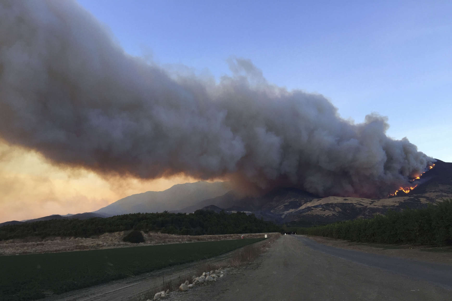 A wildfire burns off of the hills next to CA-126 highway, just northwest of Fillmore, Calif, Thursday, Dec. 7, 2017. Thousands of homes remain threatened by at least four major Southern California wildfires that have destroyed structures and sent residents fleeing. (AP Photo/Amanda Lee Myers)