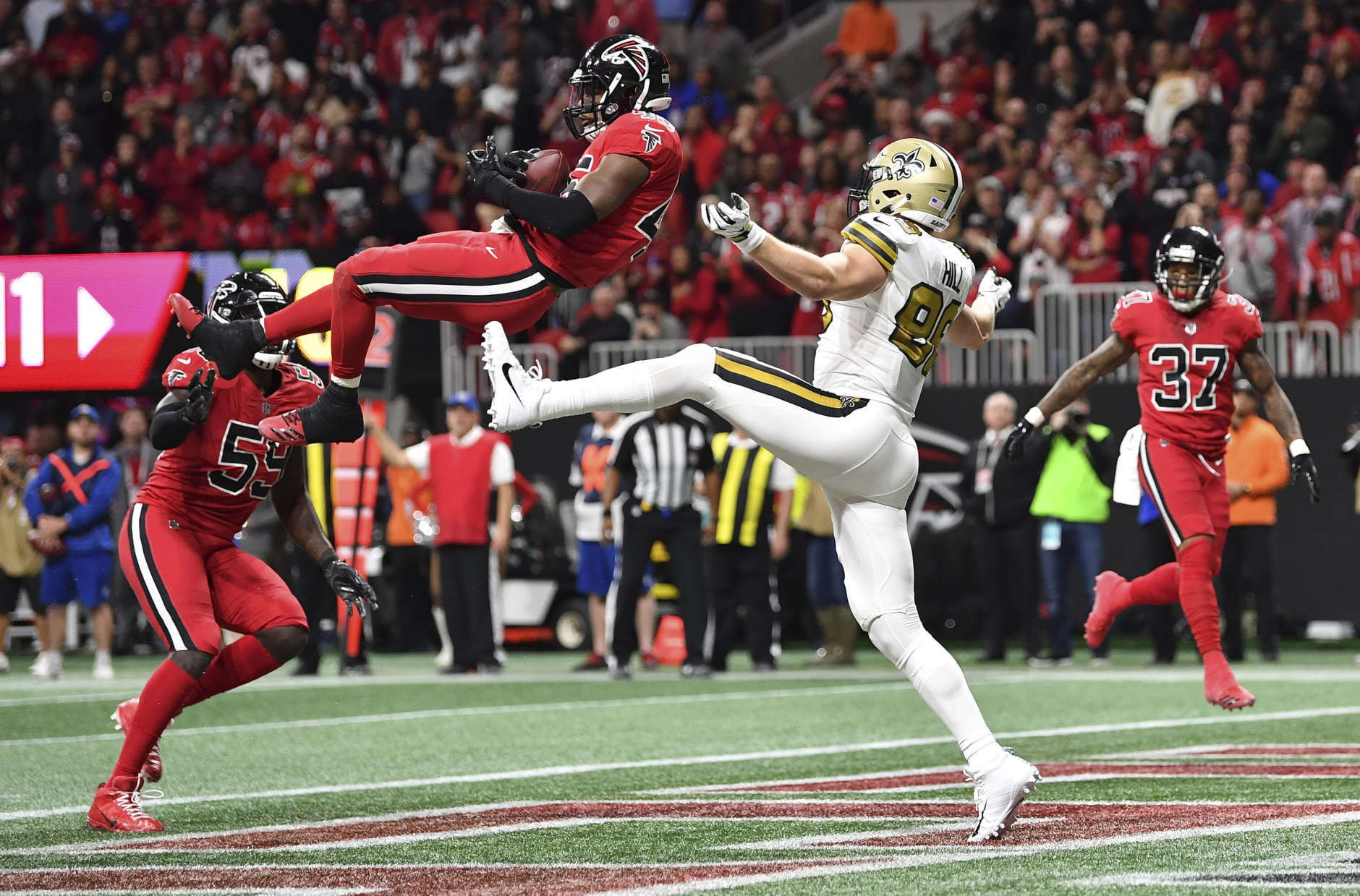Atlanta Falcons middle linebacker Deion Jones (45) intercepts a ball in the end zone ahead of New Orleans Saints tight end Josh Hill (89) during the second half of an NFL football game, Thursday, Dec. 7, 2017, in Atlanta. (AP Photo/Danny Karnik)