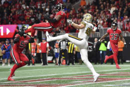 Atlanta Falcons middle linebacker Deion Jones (45) intercepts a ball in the end zone ahead of New Orleans Saints tight end Josh Hill (89) during the second half of an NFL football game, Thursday, Dec. 7, 2017, in Atlanta. (AP Photo/Danny Karnik)