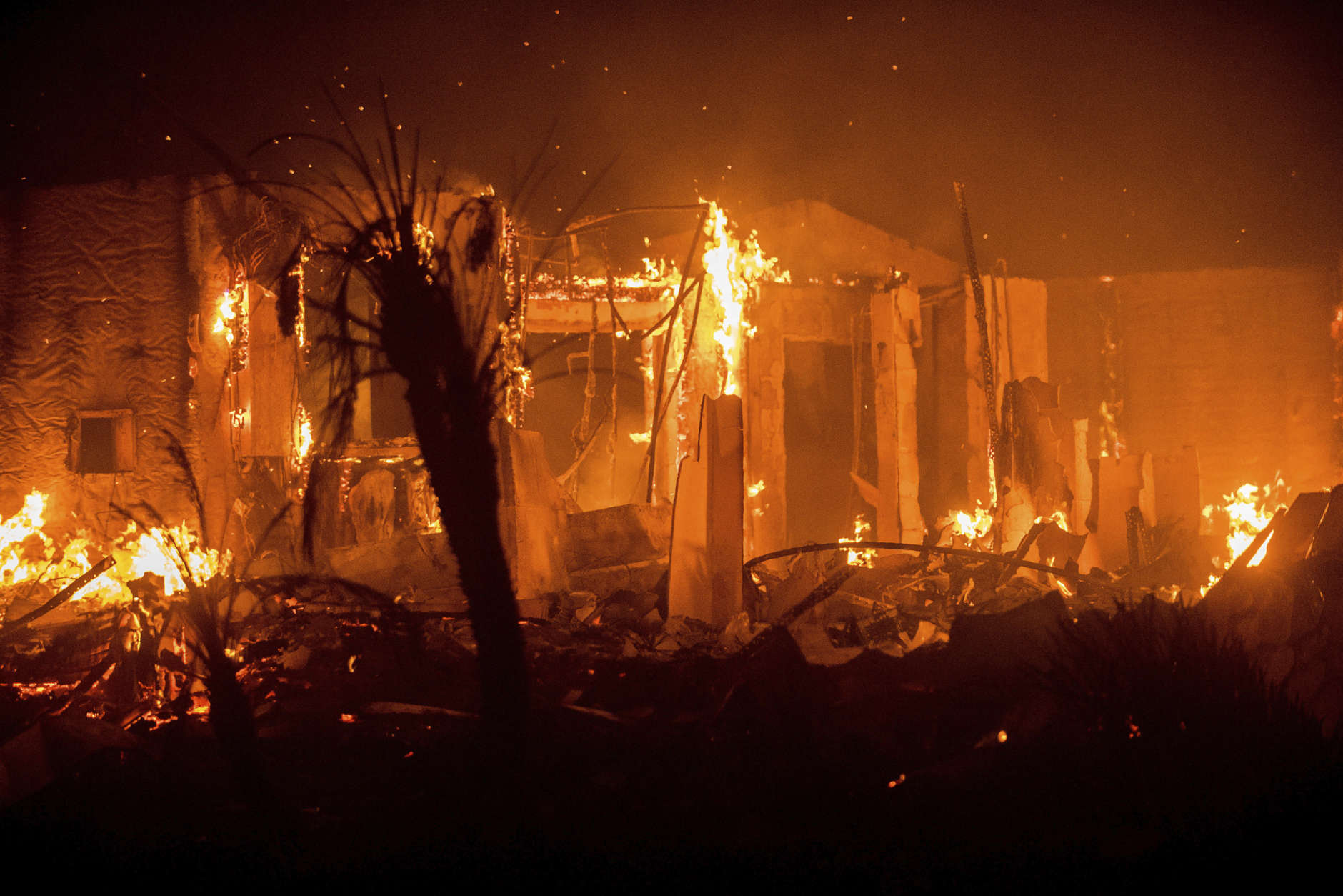 Flames consume a structure as the Lilac fire burns in Bonsai, Calif., on Friday, Dec. 8, 2017. The blaze burned numerous structures and thousands of acres according to fire officials. Wind-swept blazes have forced tens of thousands of evacuations and destroyed dozens of homes in Southern California. (AP Photo/Noah Berger)