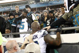 Seattle Seahawks defensive tackle Quinton Jefferson, center, tries to climb up in the stands after Jacksonville Jaguars fans threw objects at him in the closing moments of an NFL football game, Sunday, Dec. 10, 2017, in Jacksonville, Fla. Jacksonville won 30-24. (AP Photo/Stephen B. Morton)