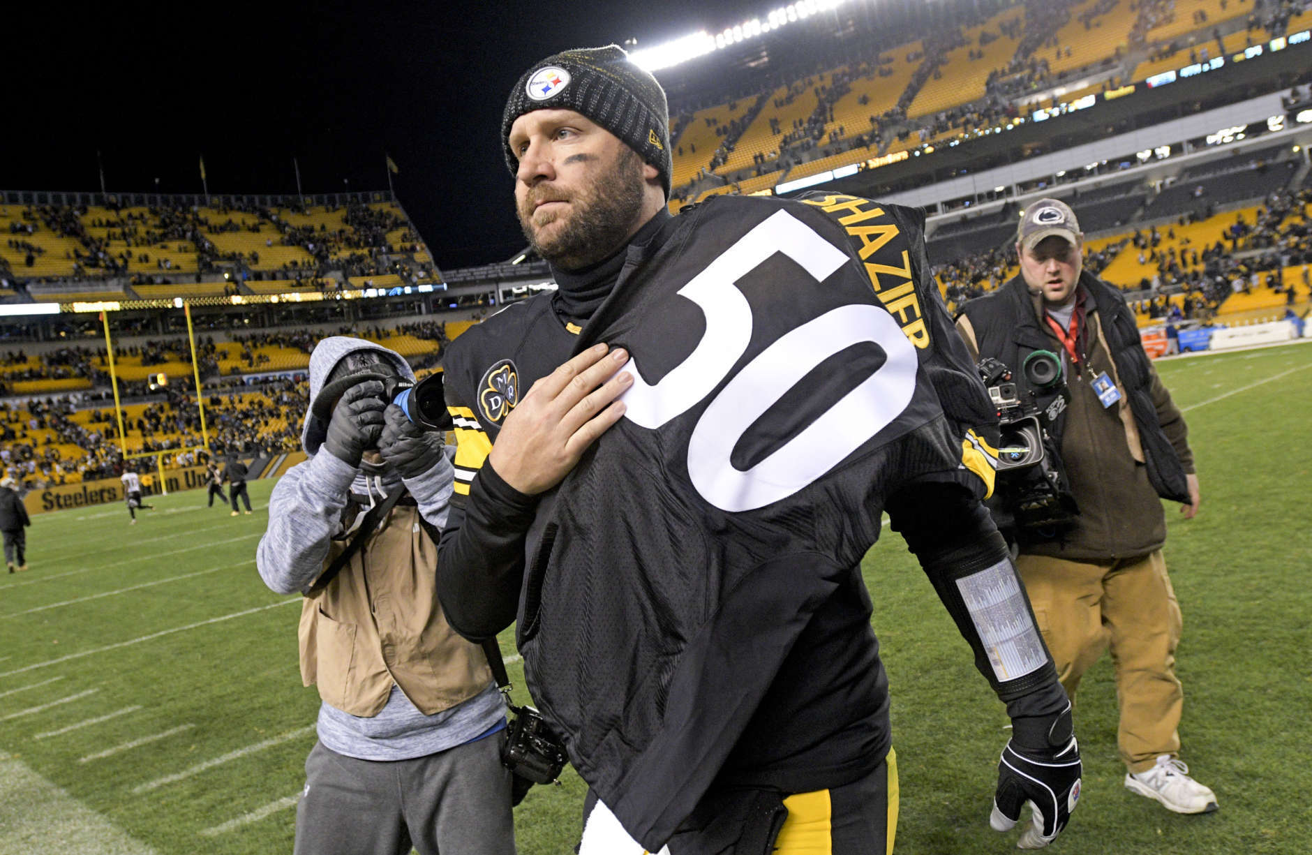 Pittsburgh Steelers quarterback Ben Roethlisberger (7) walks off the field holding the jersey of linebacker Ryan Shazier after beating the Baltimore Ravens 39-38 to clinch the AFC North Championship in an NFL football game in Pittsburgh, Monday, Dec. 11, 2017. Shazier suffered a spinal cord injury in last week's game and is recovering from surgery to stabilize his spine. (AP Photo/Don Wright)