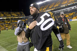 Pittsburgh Steelers quarterback Ben Roethlisberger (7) walks off the field holding the jersey of linebacker Ryan Shazier after beating the Baltimore Ravens 39-38 to clinch the AFC North Championship in an NFL football game in Pittsburgh, Monday, Dec. 11, 2017. Shazier suffered a spinal cord injury in last week's game and is recovering from surgery to stabilize his spine. (AP Photo/Don Wright)