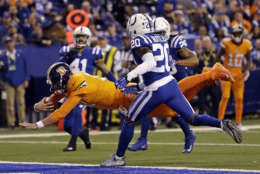 Denver Broncos quarterback Brock Osweiler (17) dives in for a touchdown in front of Indianapolis Colts free safety Darius Butler (20) during the first half of an NFL football game in Indianapolis, Thursday, Dec. 14, 2017. (AP Photo/AJ Mast)