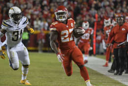 Kansas City Chiefs running back Kareem Hunt (27) is pursued by Los Angeles Chargers safety Adrian Phillips (31) during the first half of an NFL football game in Kansas City, Mo., Saturday, Dec. 16, 2017. (AP Photo/Ed Zurga)