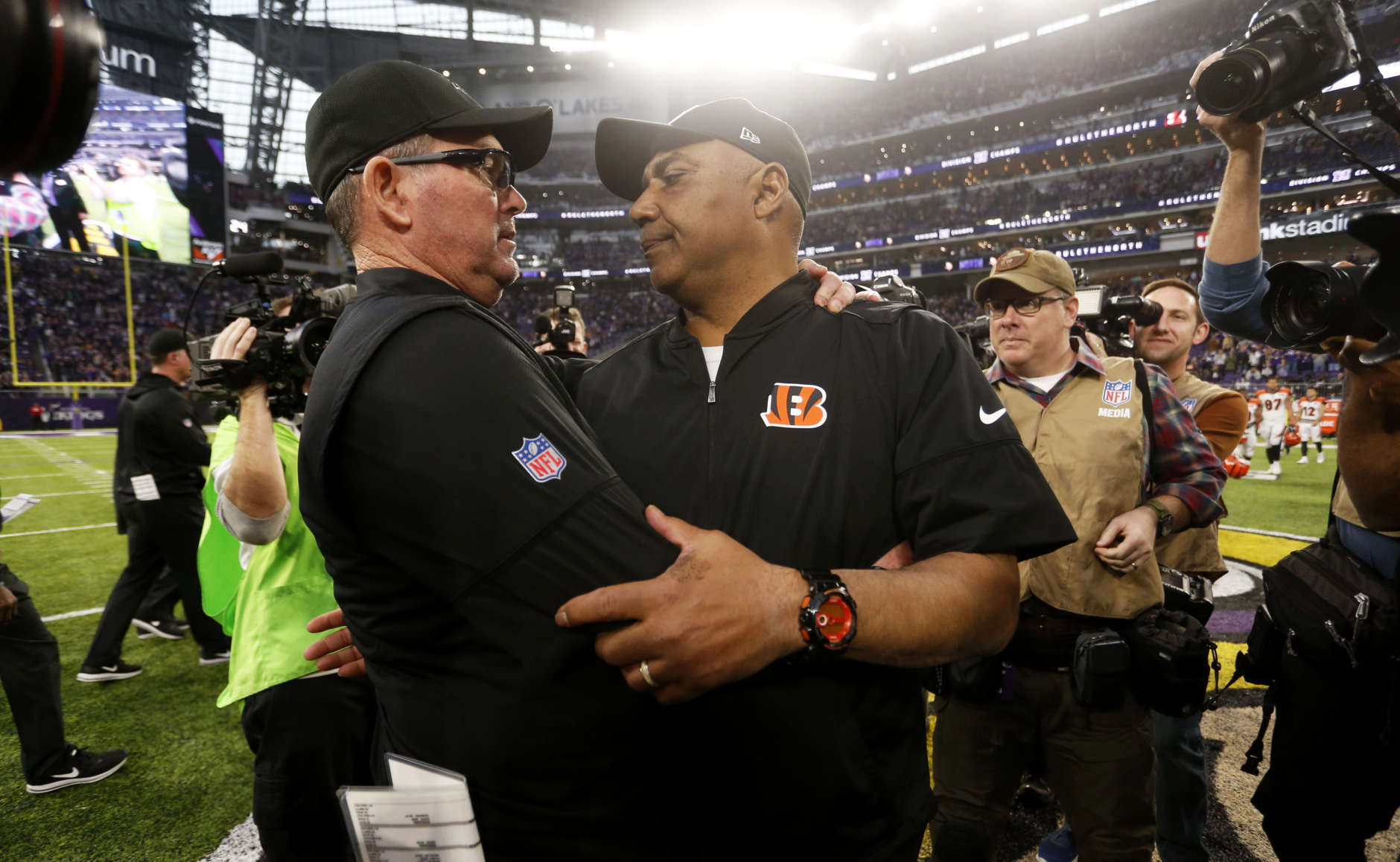 Cincinnati Bengals head coach Marvin Lewis, front right, talks with Minnesota Vikings head coach Mike Zimmer, left, after an NFL football game, Sunday, Dec. 17, 2017, in Minneapolis. (AP Photo/Bruce Kluckhohn)