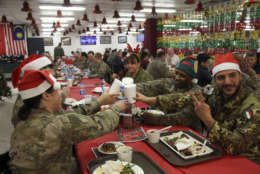 Members of the U.S. military eat Christmas dinner at the Resolute Support Headquarters in Kabul, Afghanistan, Monday, Dec. 25, 2017. (AP Photo/Rahmat Gul)