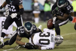 Oakland Raiders' Jalen Richard (30) fumbles the ball against Philadelphia Eagles' Rodney McLeod (23) and Malcolm Jenkins (27) during the second half of an NFL football game, Monday, Dec. 25, 2017, in Philadelphia. (AP Photo/Michael Perez)