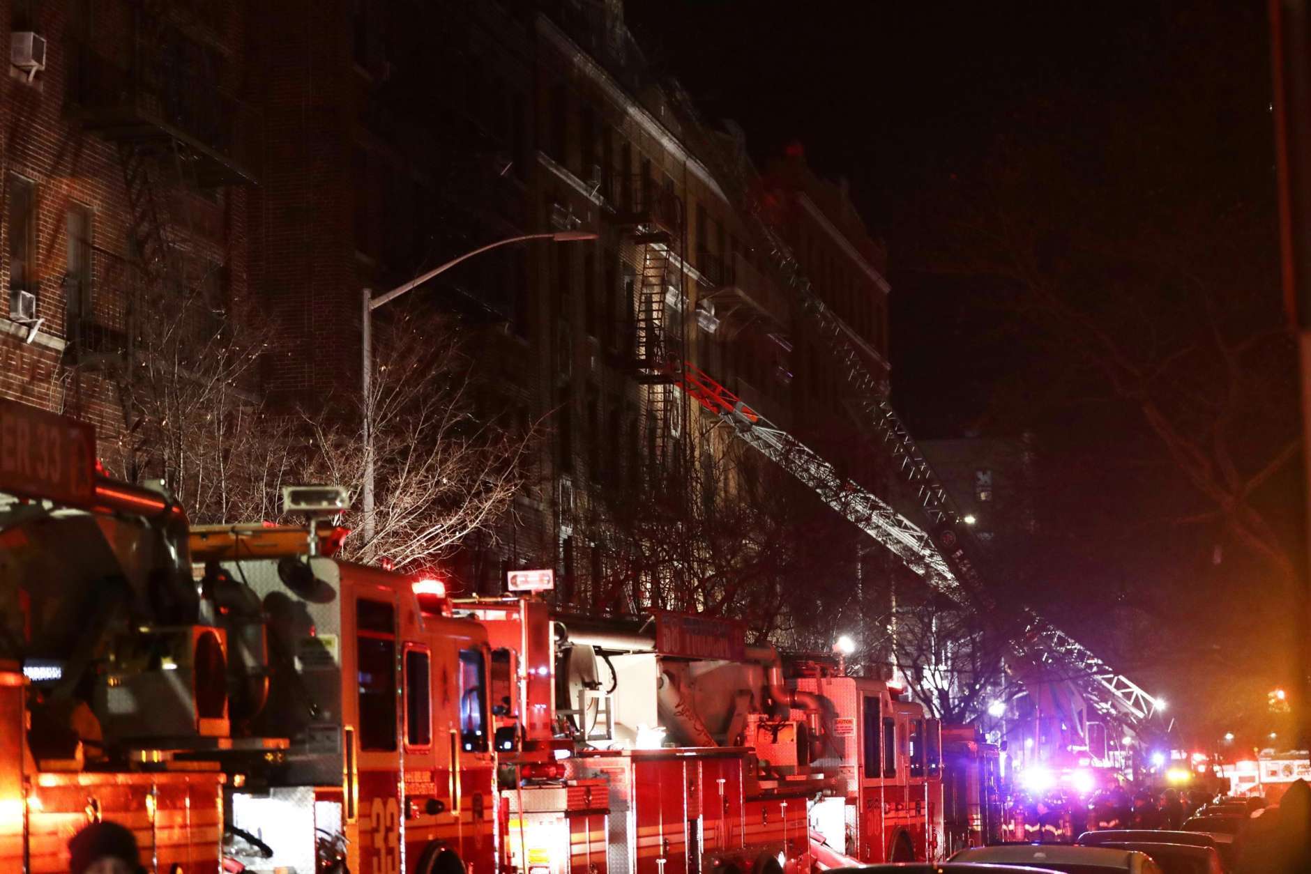 Firefighters respond to a building fire Thursday, Dec. 28, 2017, in the Bronx borough of New York. The Fire Department of New York says a blaze raging in the Bronx apartment building has seriously injured more than a dozen of people. (AP Photo/Frank Franklin II)