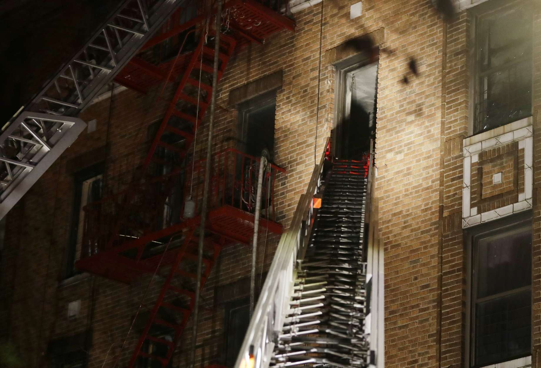 Firefighters respond to a deadly fire Thursday, Dec. 28, 2017, in the Bronx borough of New York. The New York City mayor's press secretary says several people have died in the blaze on a frigid night, and several more have been injured.  (AP Photo/Frank Franklin II)
