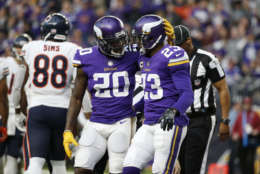 Minnesota Vikings cornerback Mackensie Alexander (20) celebrates with teammate Terence Newman (23) during the second half of an NFL football game against the Chicago Bears, Sunday, Dec. 31, 2017, in Minneapolis. (AP Photo/Bruce Kluckhohn)