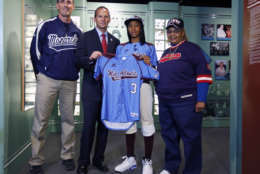 Little League pitcher Mo'ne Davis, second from right, presents the jersey she wore during her shutout win at the Little League World Series to Baseball Hall of Fame President Jeff Idelson  during a ceremony at the hall on Thursday, Sept. 25, 2014, in Cooperstown, N.Y. Also pictured are Steve Bandura, left, who runs the Anderson Monarchs baseball program and Mamie "Peanut" Johnson, who pitched in the Negro Leagues. (AP Photo/Mike Groll)