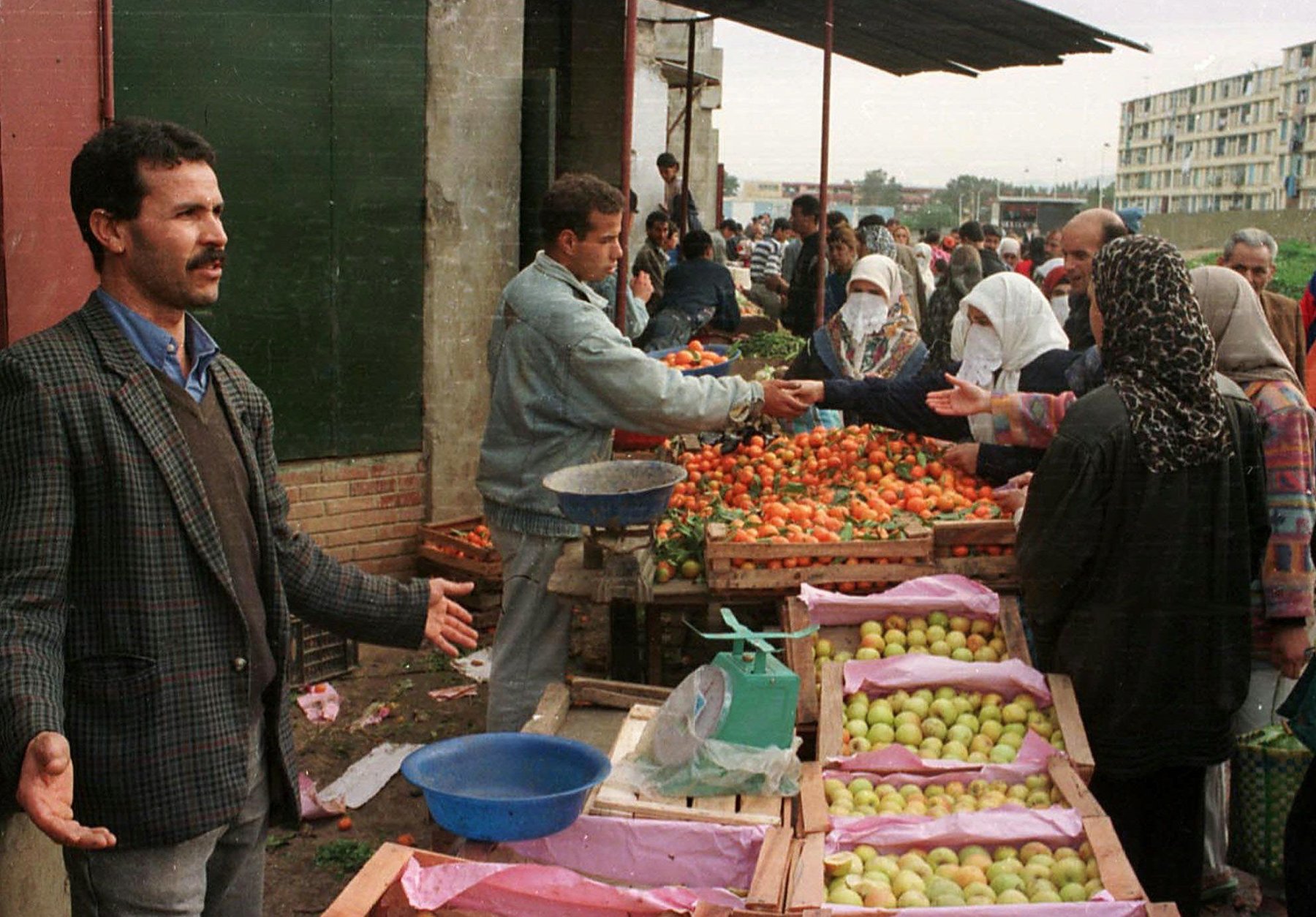 Algerians of the Badjarah district of Algiers go shopping in preparation for the holy month of Ramadan, Tuesday Dec. 30, 1997.  Road-side attackers and village raiders wielding knives and guns killed 58 people in Algeria in recent days according to witnesses and newspaper reports Tuesday. (AP PHOTO)