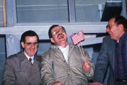 Three former U.S. hostages, from left, Joseph Cicippio, AP chief Middle East correspondent Terry Anderson, and Alann Steen enjoy a light moment shortly after Anderson's arrival at the Wiesbaden Air Force hospital early Thursday, Dec. 5, 1991.  (AP Photo/Kurt Strumpf)