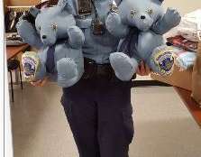 A D.C. officer with the bears made from Officer Barry Eastman's uniform. (Courtesy Metropolitan Police Department)