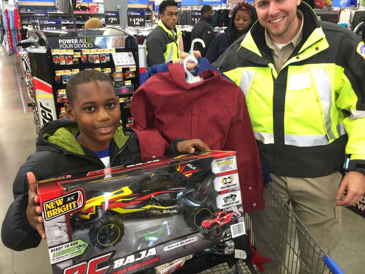 Emmanuel, 11, chooses the fastest remote control car he could find with D.C. Recruit Officer Jordan Murch on Wednesday, Dec. 6, 2017. (WTOP/Kristi King)