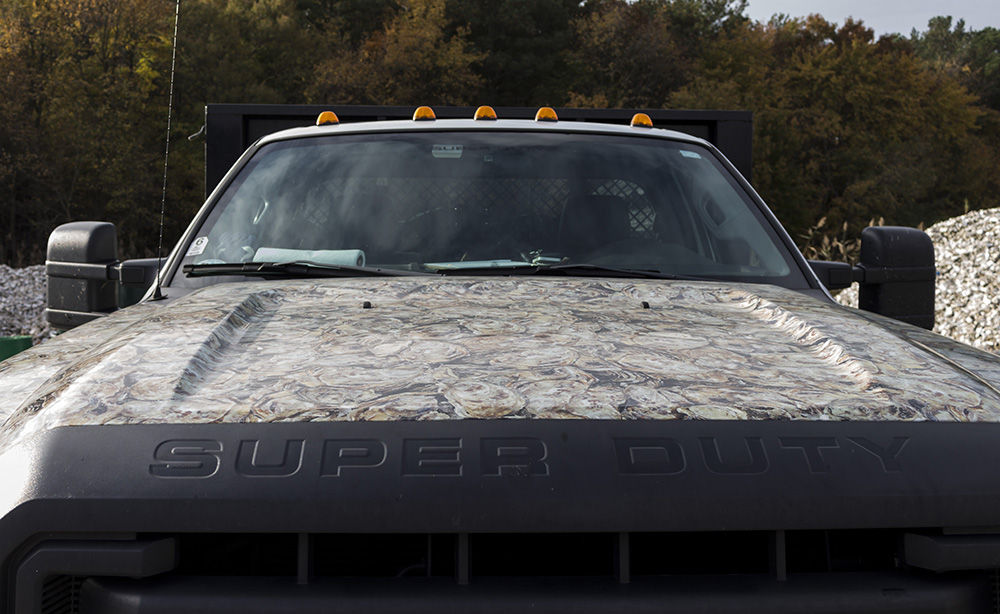 The Oyster Recovery Partnership’s Ford F-550 truck has an oyster-camouflage hood. (Alex Mann/Capital News Service) 