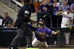 LSU's Kramer Robertson, right, reacts after being called out at home plate by umpire Troy Fullwood in the eighth inning against Florida in Game 2 of the NCAA College World Series baseball finals in Omaha, Neb., Tuesday, June 27, 2017. (AP Photo/Nati Harnik)