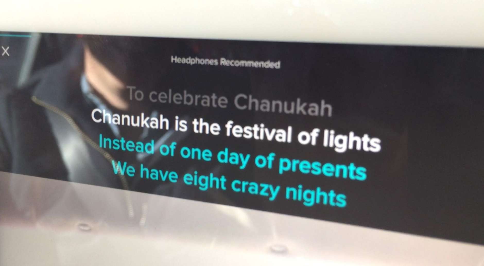 Karaoke lyrics to “The Chanukah Song” scroll on the Lyft Merry Mode car’s iPad. (WTOP/Kristi King)