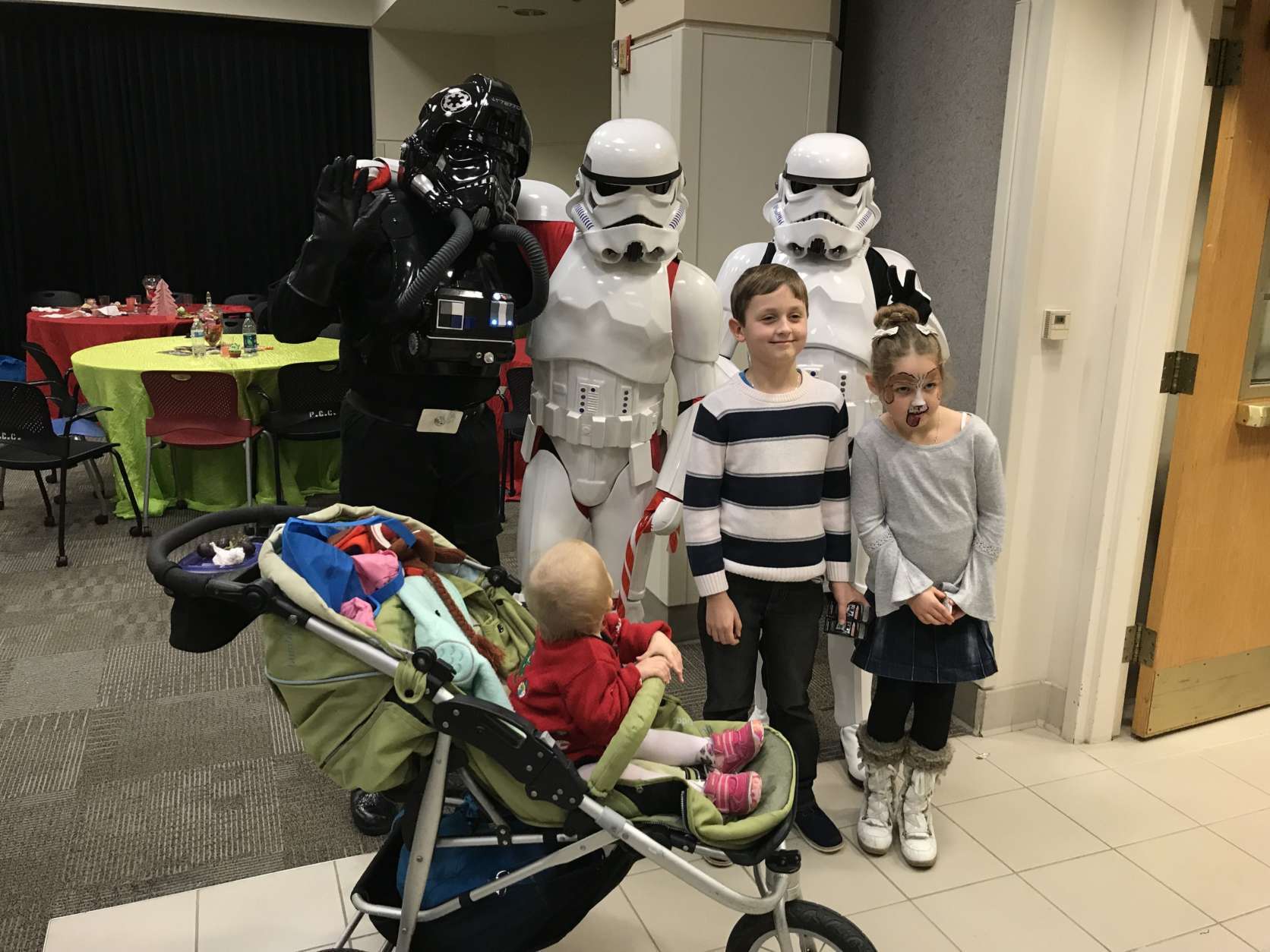 Three Star Wars bad guys pose with three kids, including one who can’t stop staring. (WTOP/Michelle Basch)