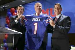 New SMU head football coach Sonny Dykes, center, holds up a jersey with university president Gerald Turner, left, and athletic director Rick Hart after Dykes' introduction in Dallas, Tuesday, Dec. 12, 2017. SMU hired the former California and Louisiana Tech coach as its new coach, replacing one Texan with reputation for directing potent offenses for another. Dykes will replace Chad Morris, who left SMU last week to become Arkansas' coach.(AP Photo/LM Otero)