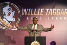 FILE - In this Dec. 6, 2017, file photo, Willie Taggart gestures as he is introduced as Florida State's new football coach during an NCAA college football news conference in Tallahassee, Fla. A potential new tax on seven-figure salaries for employees of non-profits hasn’t deterred schools from doling out huge contracts to new coaches. (AP Photo/Mark Wallheiser, File)