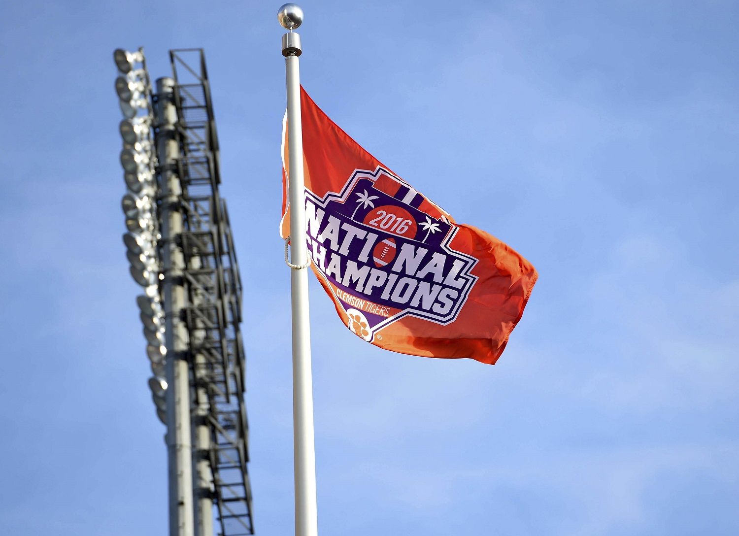 A championship flag flutters at Doug Kingsmore Stadium as the Clemson Tigers returned Tuesday, Jan. 10, 2017, to Clemson, S.C., the day after Clemson defeated Alabama 35-31 in the NCAA College Football Playoff championship game in Tampa, Fla. (AP Photo/Richard Shiro)