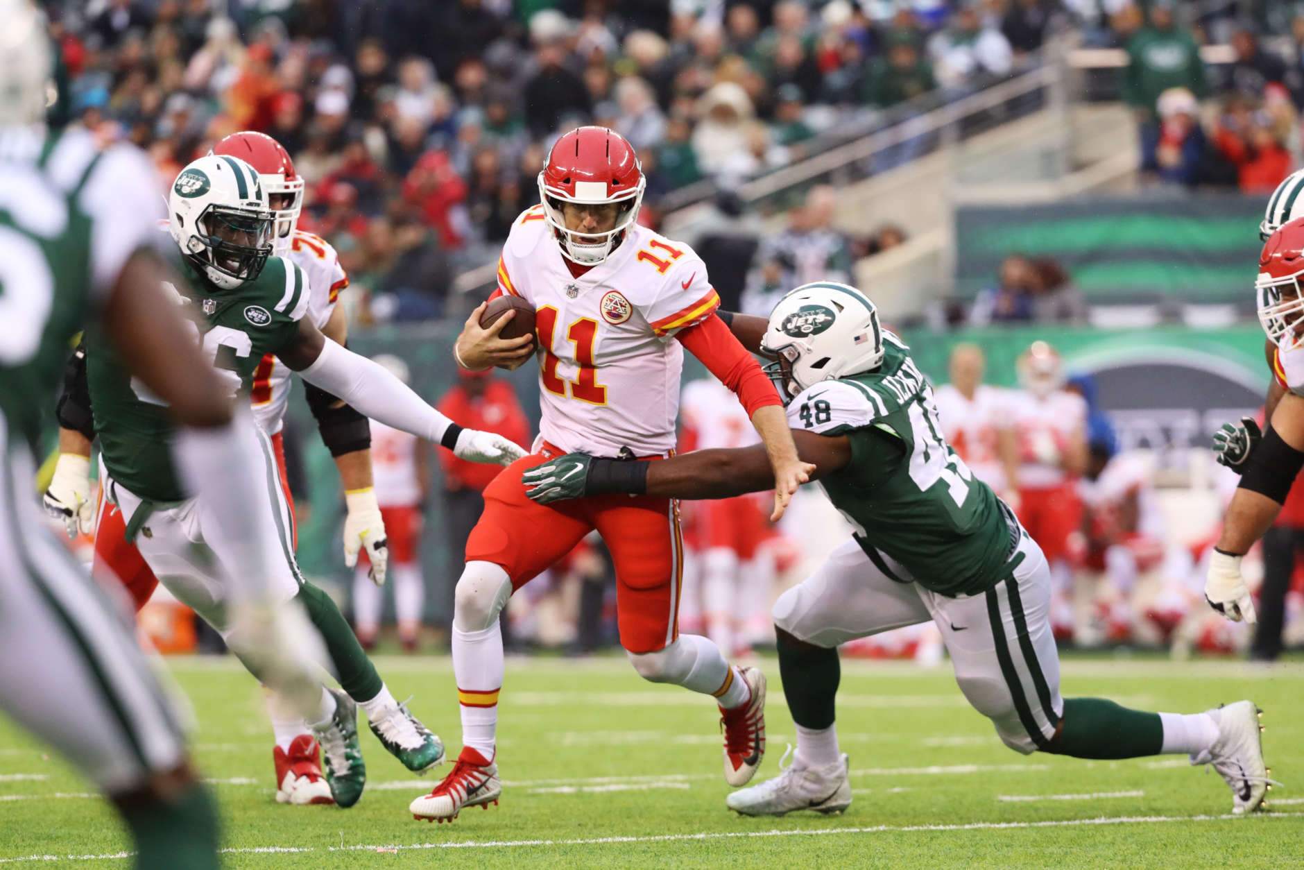 EAST RUTHERFORD, NJ - DECEMBER 03:  Alex Smith #11 of the Kansas City Chiefs makes a run against  Jordan Jenkins #48 of the New York Jets during their game at MetLife Stadium on December 3, 2017 in East Rutherford, New Jersey.  (Photo by Abbie Parr/Getty Images)