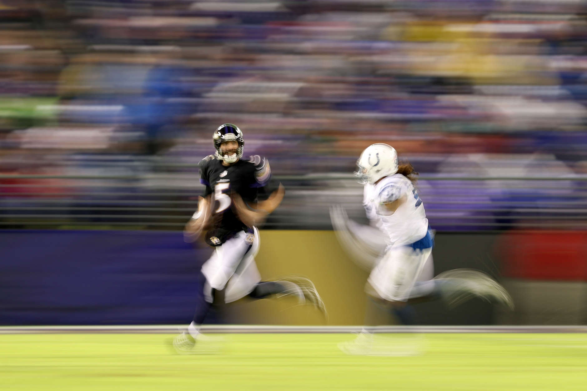 BALTIMORE, MD - DECEMBER 23: Quarterback Joe Flacco #5 of the Baltimore Ravens runs with the ball in the third quarter against the Indianapolis Colts at M&amp;T Bank Stadium on December 23, 2017 in Baltimore, Maryland. (Photo by Patrick Smith/Getty Images)