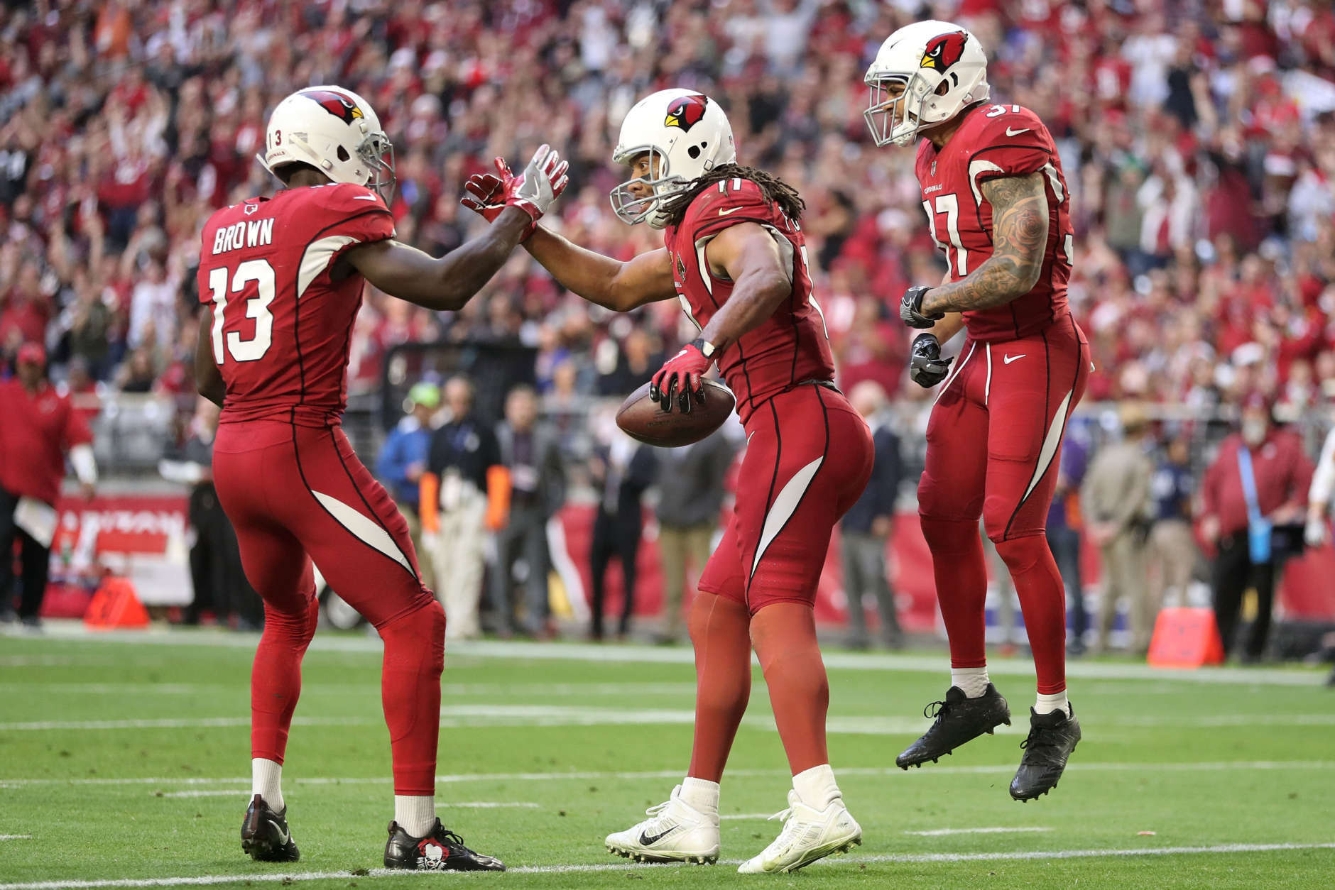 GLENDALE, AZ - DECEMBER 24:  Wide receiver Larry Fitzgerald #11 of the Arizona Cardinals celebrates a thirteen yard touchdown with wide receiver Jaron Brown #13 and running back D.J. Foster #37 in the first half of the NFL game against the New York Giants at University of Phoenix Stadium on December 24, 2017 in Glendale, Arizona.  (Photo by Christian Petersen/Getty Images)